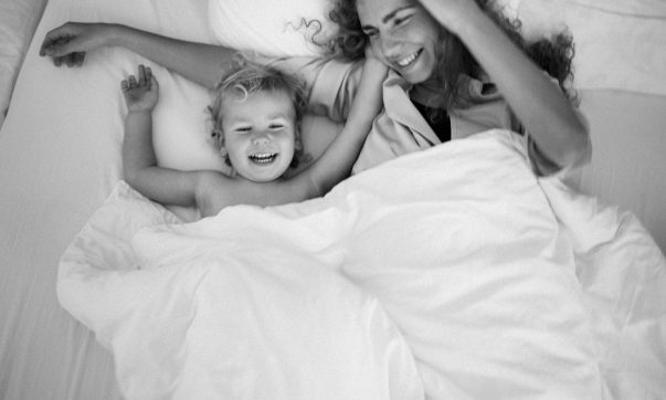 une maman et son enfant sous une couette