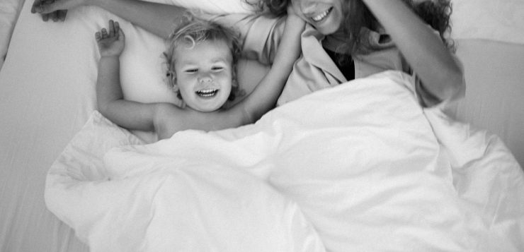 une maman et son enfant sous une couette