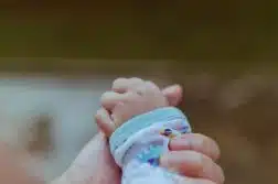 person holding baby's hand